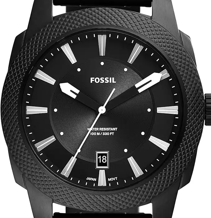 Close-up of the Fossil Machine men's watch featuring a black textured bezel and bold analog dial